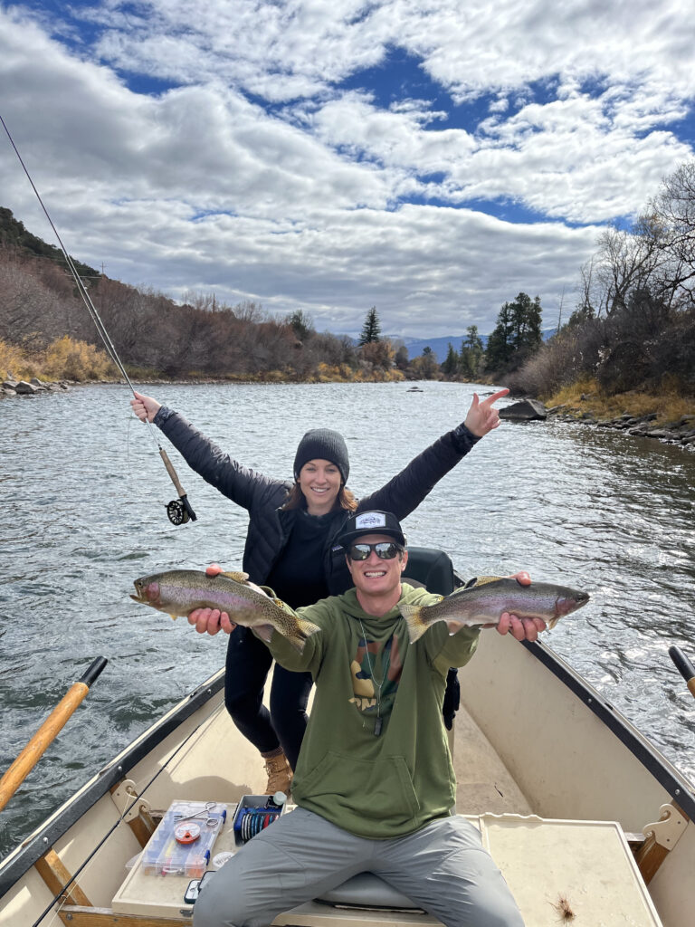 Colorado fly fishing guides with anglers showcasing rainbow trout on the river