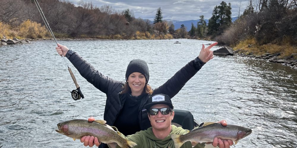 Colorado fly fishing guides with anglers showcasing rainbow trout on the river
